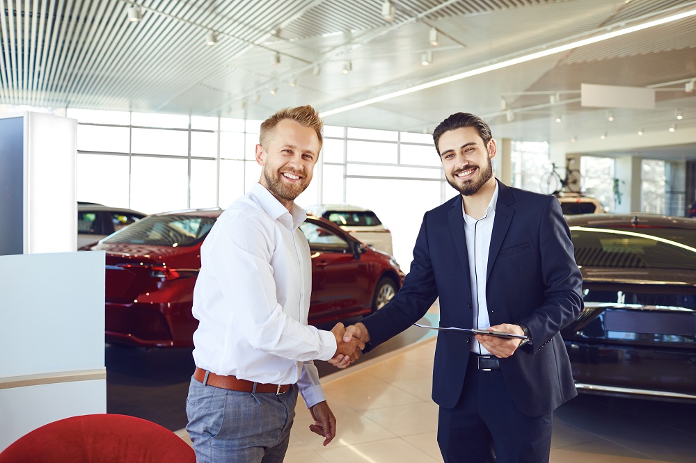 Man Shaking Car Salesman Hand